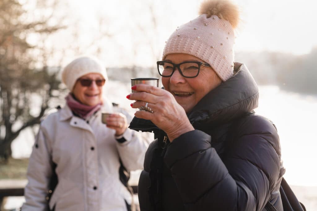 Two women enjoying drinks one winter afternoon.